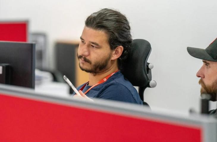 Two employees collaborating at a desk 